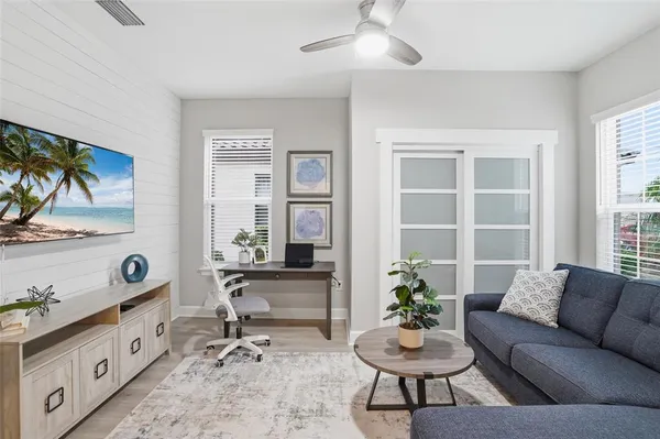 a living room with furniture potted plant and window