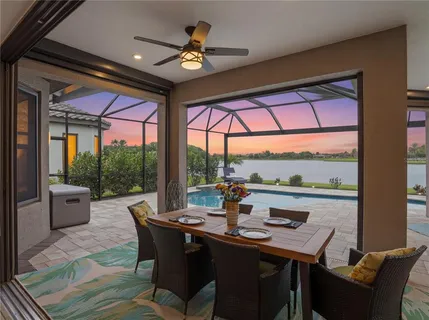 a living room with furniture a large window and a flat screen tv