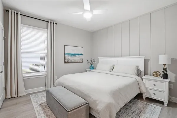 a bedroom with a large bed and a window