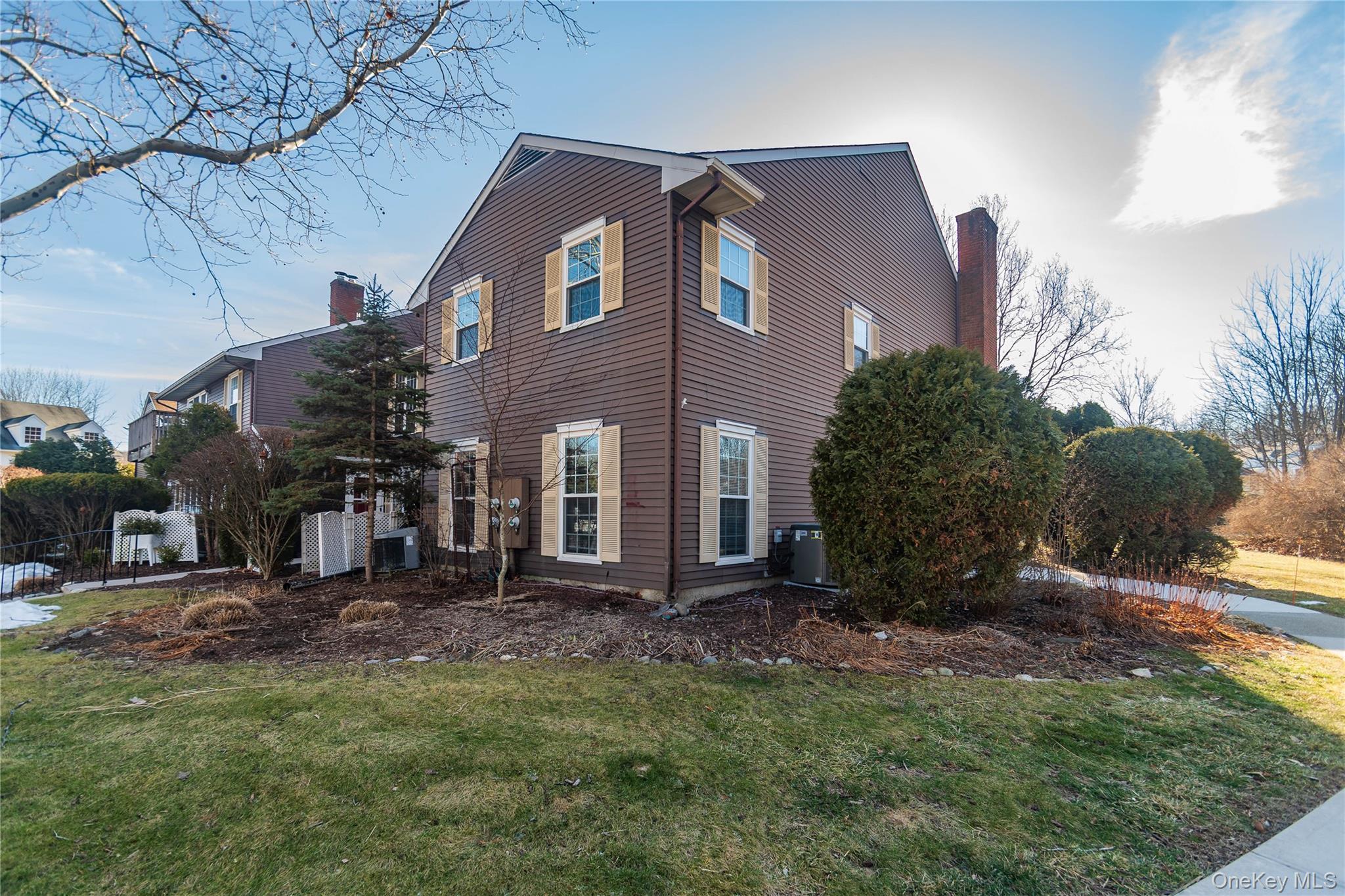 29 The Rise Warwick, NY 10990 - Photo 28 of 34 Side view of the property with walkway that takes you to the entrance to the unit, it is very private and faces the woods but yet has easy access to the parking lot.