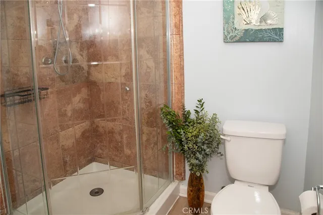 a bathroom with a toilet and a shower