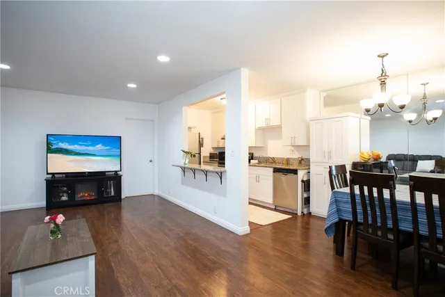 a living room with furniture wooden floor and a flat screen tv