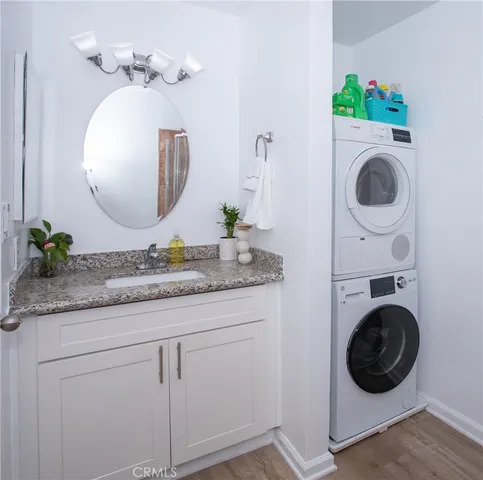 a bathroom with a granite countertop toilet sink and mirror