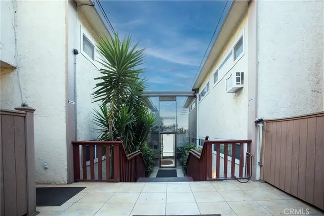 a view of a house with a cars park side of a house