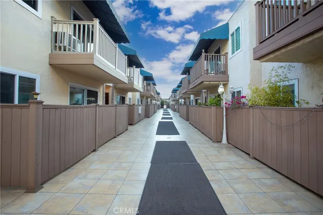 a view of backyard with potted plants and floor to ceiling window