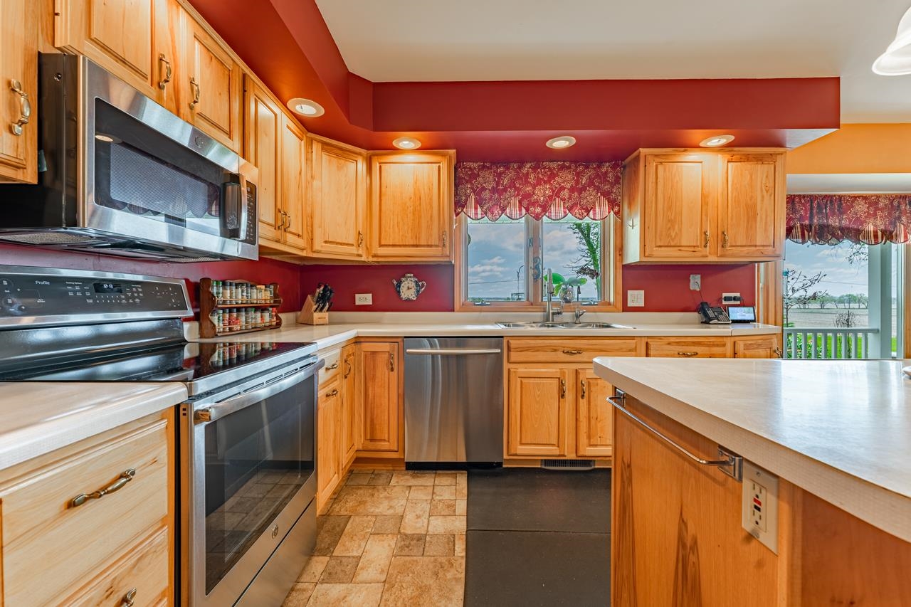 3013 Pagles Road Harvard, IL 60033 - Photo 13 of 35 a kitchen with stainless steel appliances granite countertop a stove a sink and a microwave