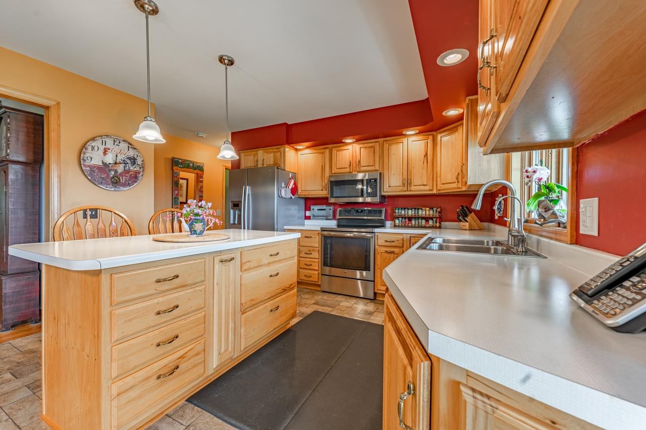 3013 Pagles Road Harvard, IL 60033 - Photo 14 of 35 a kitchen with stainless steel appliances kitchen island granite countertop a sink and a stove