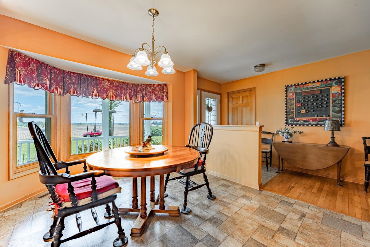 3013 Pagles Road Harvard, IL 60033 - Photo 15 of 35 a dining room with furniture a chandelier and wooden floor