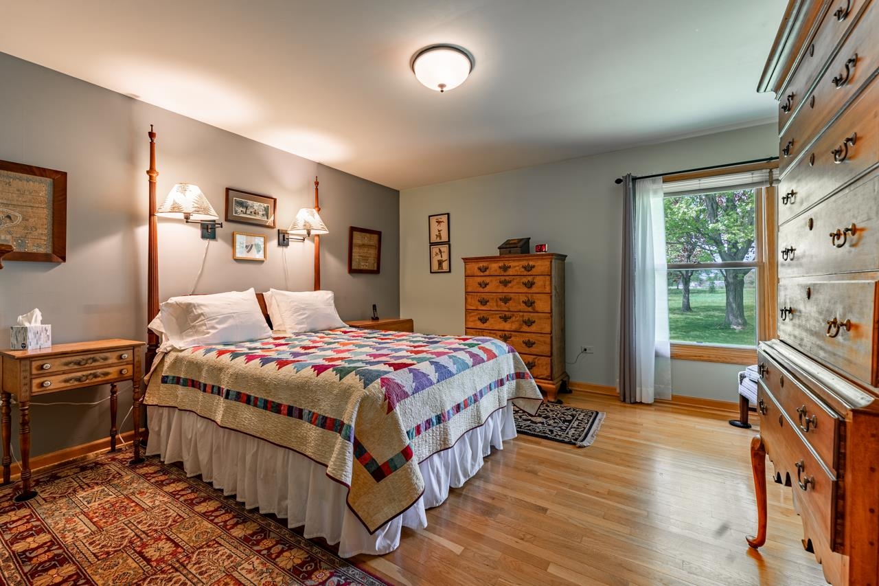 3013 Pagles Road Harvard, IL 60033 - Photo 16 of 35 a bedroom with a bed and a dresser next to a window