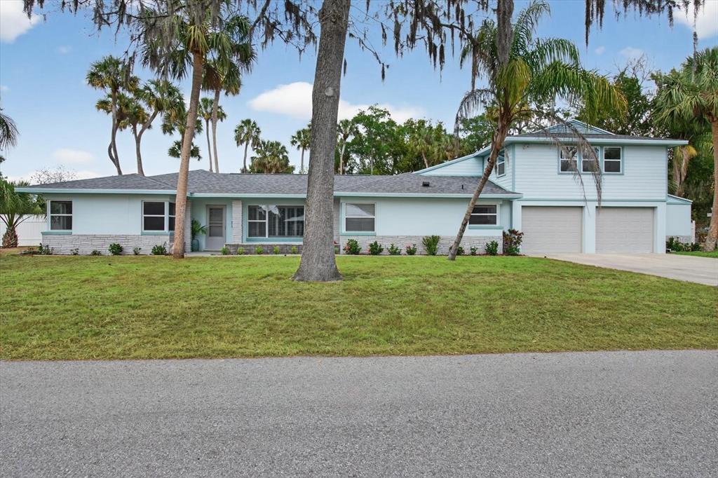 5539 Delaware Avenue New Port Richey, FL 34652 - Photo 14 of 95 a front view of house with yard and green space