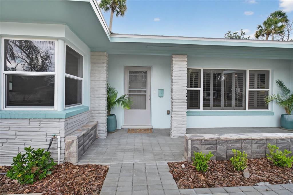 5539 Delaware Avenue New Port Richey, FL 34652 - Photo 17 of 95 a front view of a house with a garden