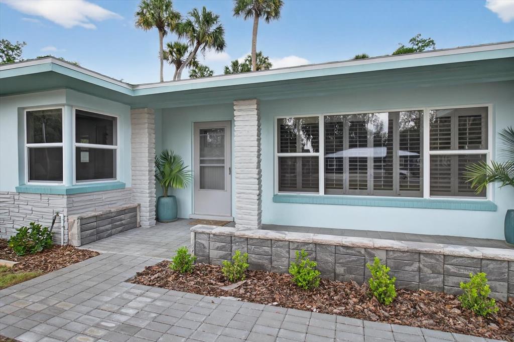 5539 Delaware Avenue New Port Richey, FL 34652 - Photo 18 of 95 a front view of a house with a garden