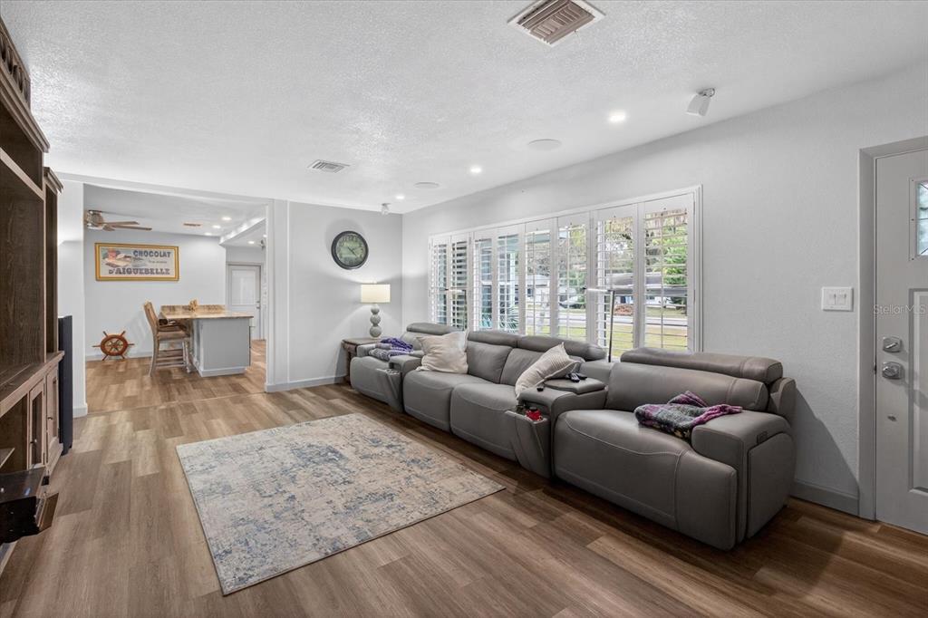 5539 Delaware Avenue New Port Richey, FL 34652 - Photo 19 of 95 a living room with furniture and a flat screen tv