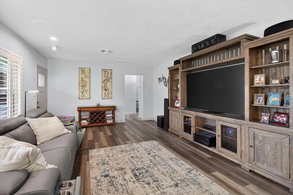 5539 Delaware Avenue New Port Richey, FL 34652 - Photo 21 of 95 a living room with furniture and a flat screen tv