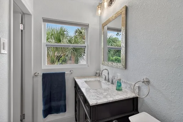 a kitchen with stainless steel appliances kitchen island granite countertop a refrigerator and cabinets