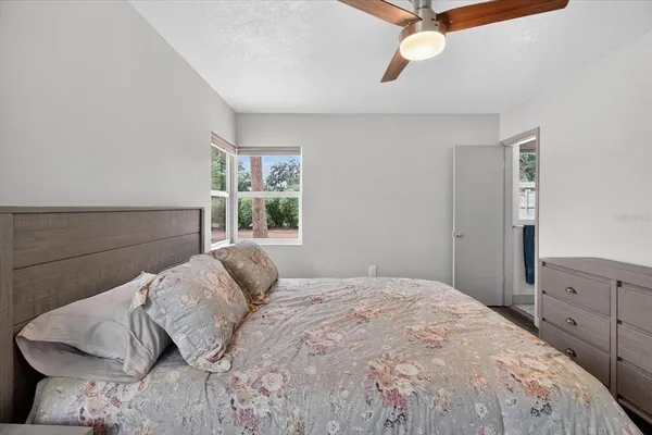 a bed sitting in a bedroom next to a window