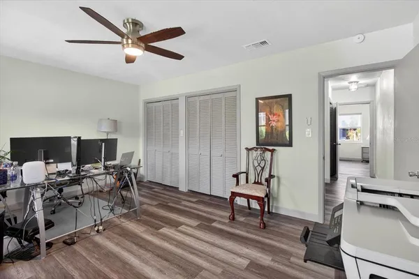 a bedroom with furniture and a wooden floor