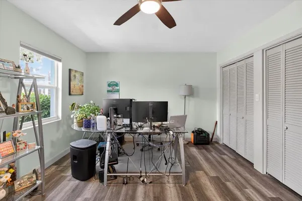 a bedroom with bed and wooden floor