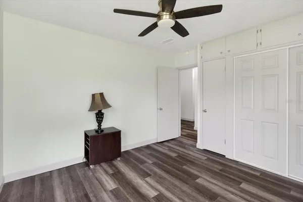 a view of a balcony with chairs and floor to ceiling window and wooden fence