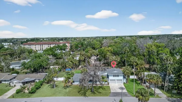 a front view of residential houses with yard and green space