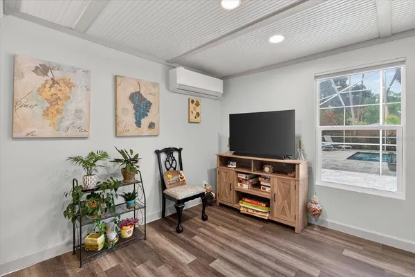 a view of a swimming pool with potted plants and more windows