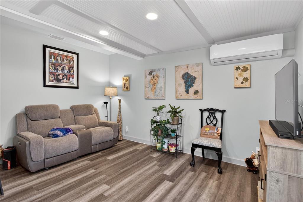 5539 Delaware Avenue New Port Richey, FL 34652 - Photo 43 of 95 a living room with furniture and a flat screen tv