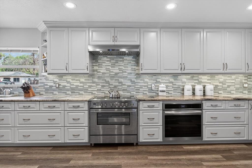 5539 Delaware Avenue New Port Richey, FL 34652 - Photo 48 of 95 a kitchen with stainless steel appliances granite countertop a stove and a sink