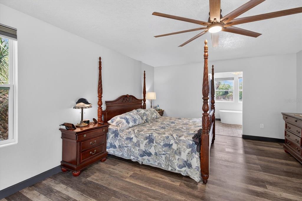 5539 Delaware Avenue New Port Richey, FL 34652 - Photo 56 of 95 a bedroom with bed and wooden floor