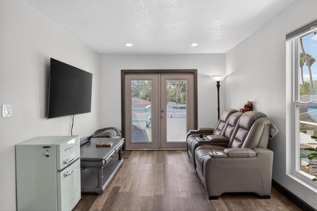 5539 Delaware Avenue New Port Richey, FL 34652 - Photo 61 of 95 a living room with furniture and a flat screen tv
