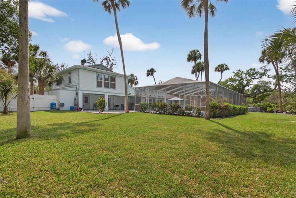 5539 Delaware Avenue New Port Richey, FL 34652 - Photo 84 of 95 a front view of a house with a garden and yard