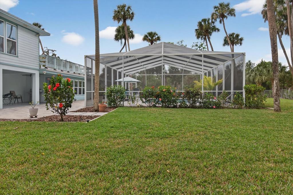 5539 Delaware Avenue New Port Richey, FL 34652 - Photo 88 of 95 a view of a big house with a big yard and potted plants