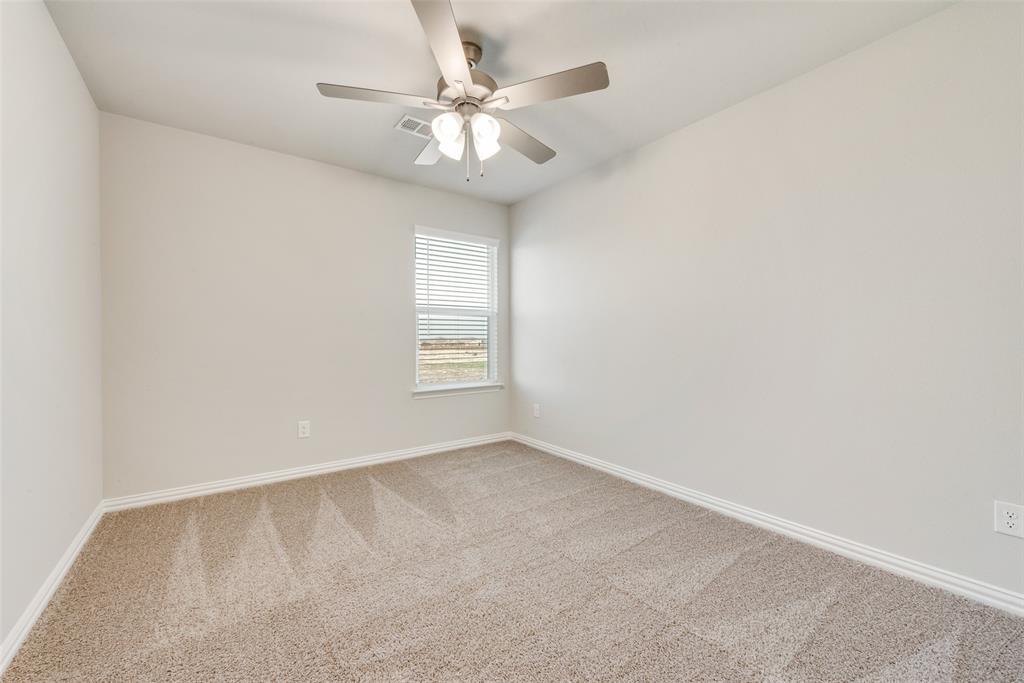 1505 Sutter Mill Road Saginaw, TX 76131 - Photo 16 of 21 an empty room with windows and fan