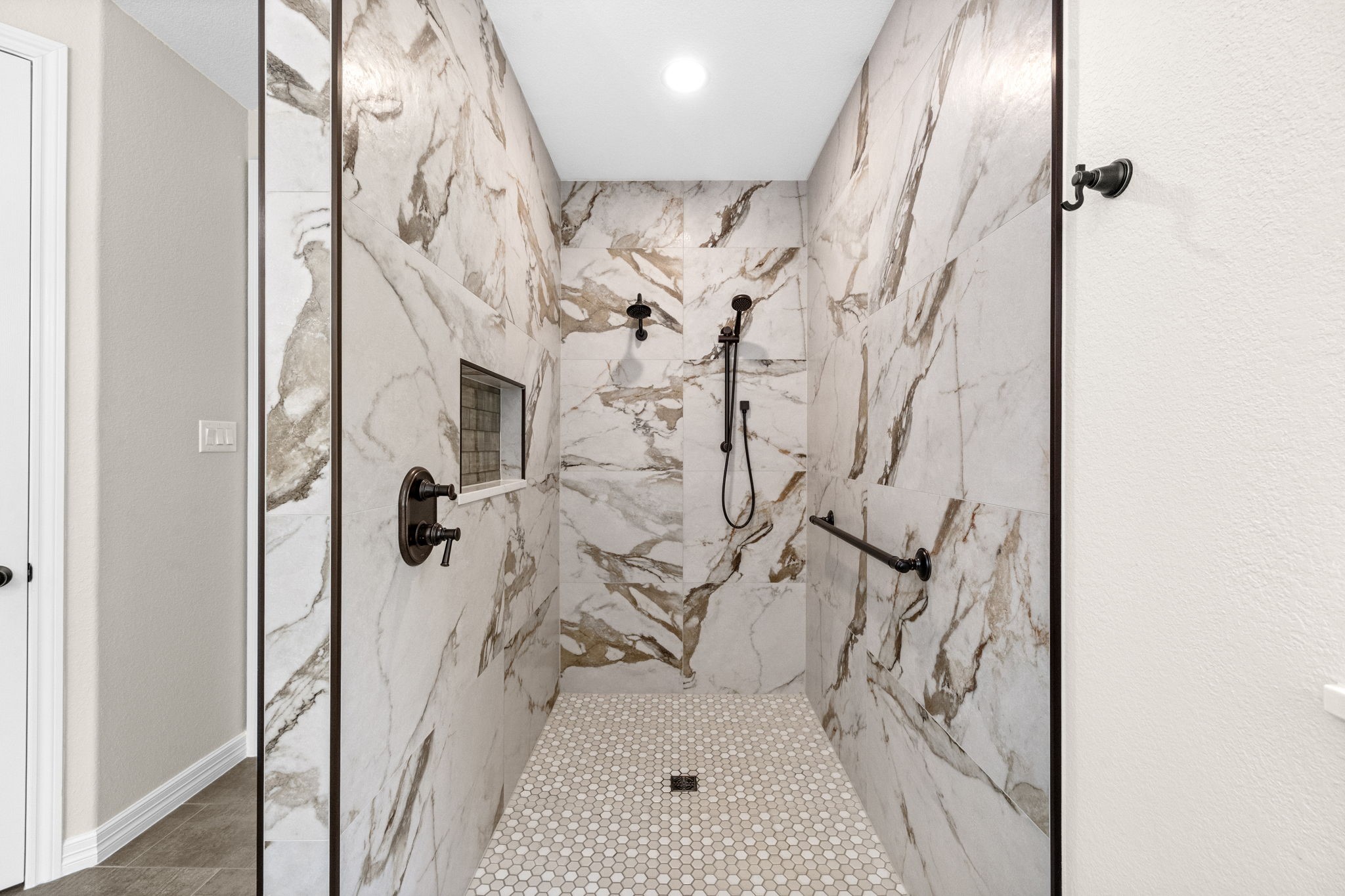 27642 Linden Ridge Lane Fulshear, TX 77441 - Photo 22 of 42 A closer look showcases the exceptional craftsmanship and designer finishes, highlighting the luxurious details that make this Spa-inspired shower both elegant and functional.