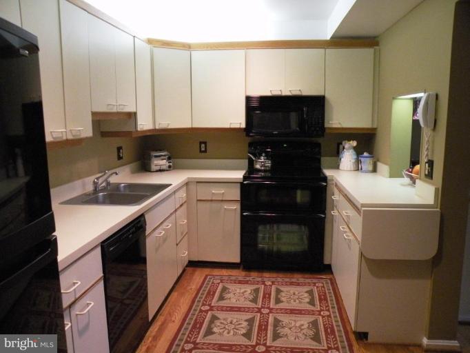 820 William Street, Unit 102 Baltimore, MD 21230 - Photo 4 of 14 a kitchen with a sink stove and refrigerator