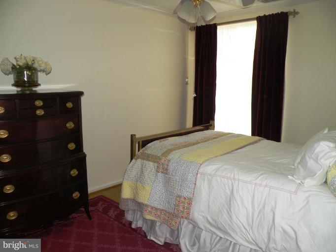 820 William Street, Unit 102 Baltimore, MD 21230 - Photo 7 of 14 a bedroom with a bed and a mirror