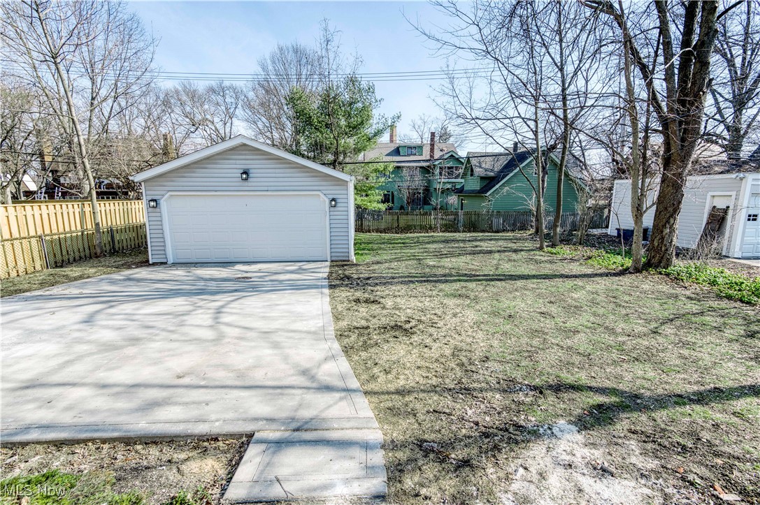 3081 Huntington Road Cleveland, OH 44120 - Photo 42 of 44 View of yard with a garage, an outdoor structure, and fence