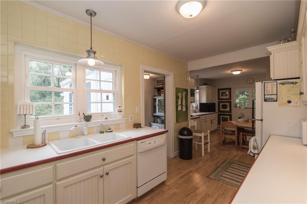 125 Jackson Road Mount Airy, NC 27030 - Photo 6 of 28 Large kitchen with corian counters, two sink areas, double ovens, eating area, jennair cooktop, and laundry closet.