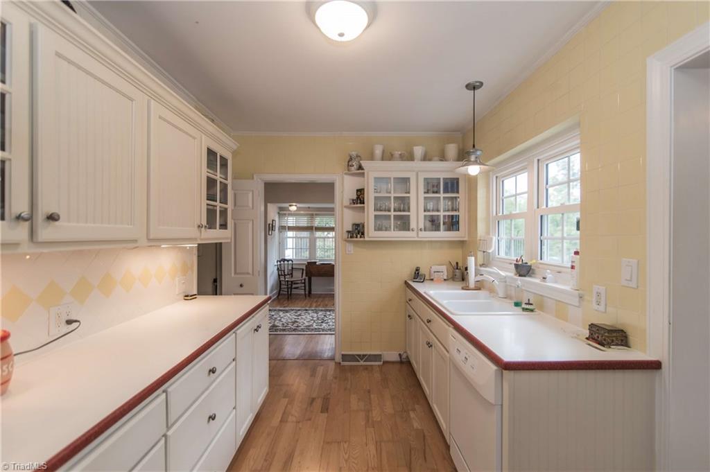125 Jackson Road Mount Airy, NC 27030 - Photo 7 of 28 Large kitchen with corian counters, two sink areas, double ovens, eating area, jennair cooktop, and laundry closet.