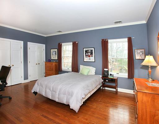 5 Shields Lane Darien, CT 06820 - Photo 16 of 20 a bedroom with a bed and wooden floor