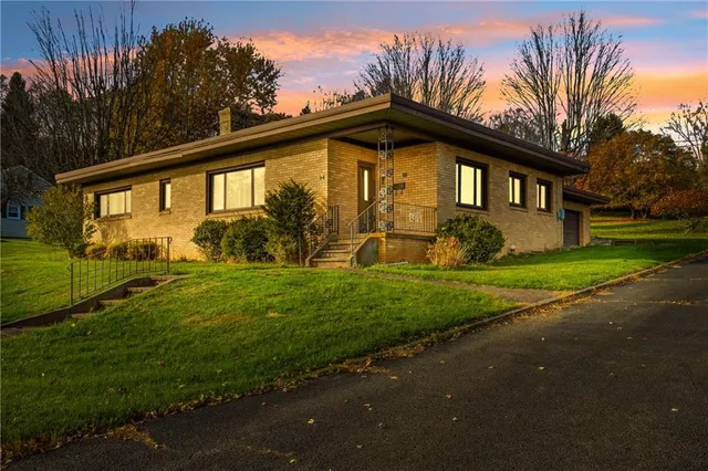 a front view of a house with garden