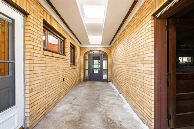 a view of a bedroom with wooden floor and ceiling fan