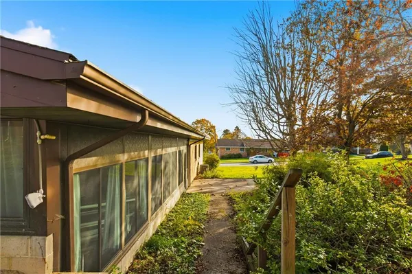 a front view of a house with a garden