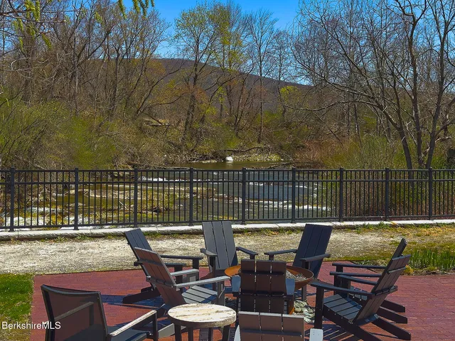 a view of a chairs and table on the roof deck