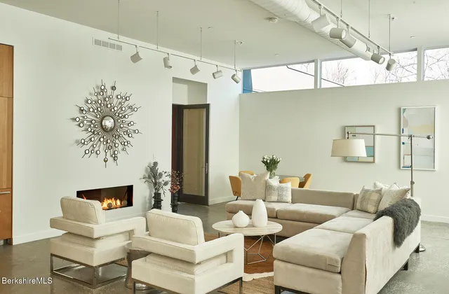 a living room with furniture and a white walls