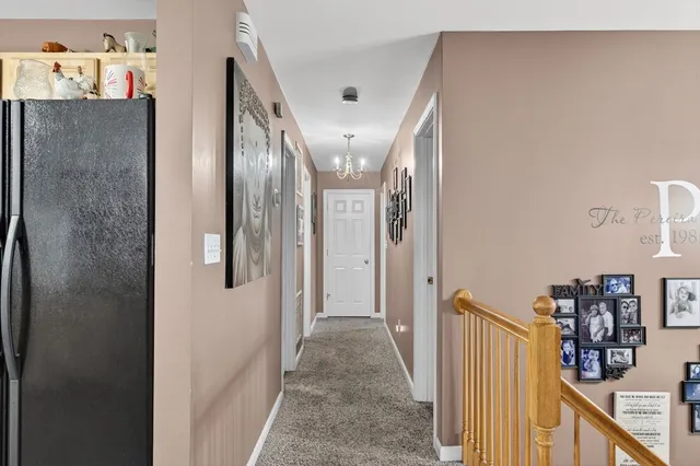 a view of a hallway with seating area