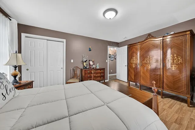 a bedroom with a large bed and a large window