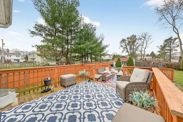 a view of deck with couches and wooden floor