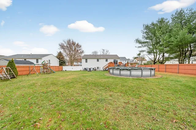a view of a house with a big yard and potted plants