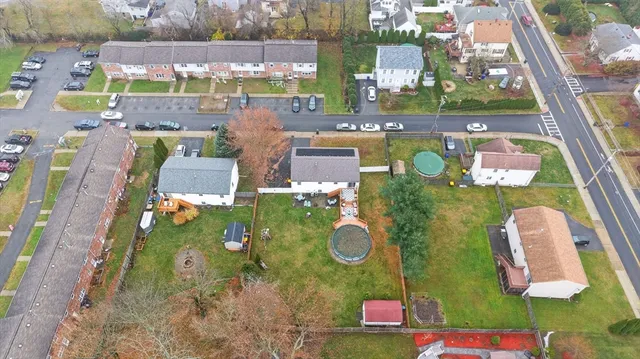 a view of swimming pool with a garden and plants