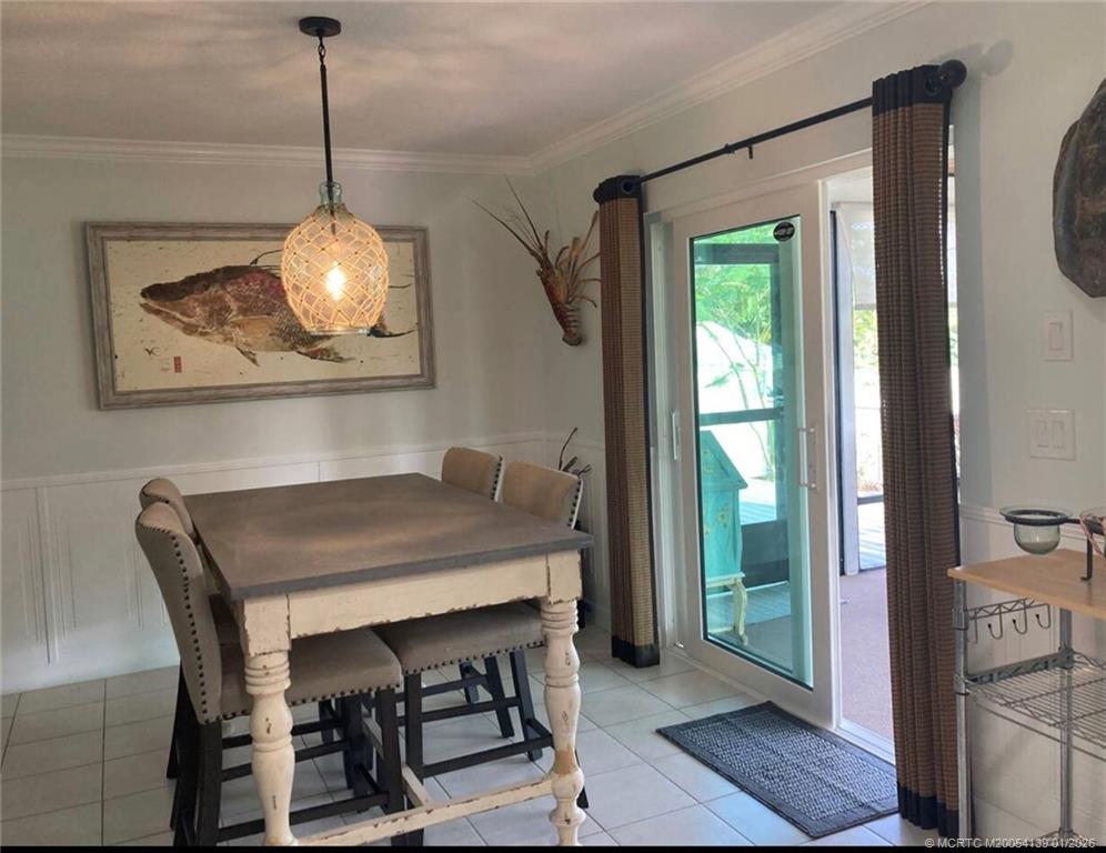4621 Southeast Shady Ridge Lane Stuart, FL 34997 - Photo 4 of 11 a view of a dining room with a table and chairs